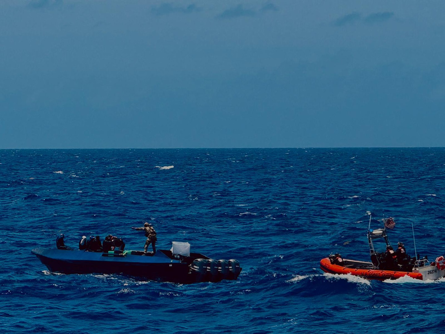Crew members from USCGC Margaret Norvell (WPC 1105) conduct a law enforcement boarding of a drug smuggling vessel located approximately 190 miles south of Puerto Rico March 24, 2024. The Coast Guard boarding team apprehended five suspected smugglers and located more than 1,850 pounds of cocaine with an estimated street value of approximately $24.3 million. (U.S. Coast Guard photo courtesy of the USCGC Margaret Norvell crew)