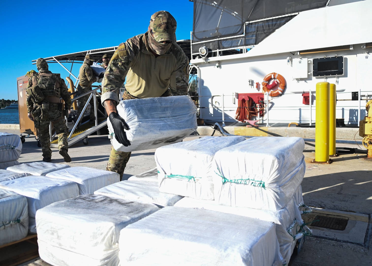 The crew of USCGC Margaret Norvell (WPC 1105) and Coast Guard Tactical Law Enforcement Team-South members celebrate a successful drug interdiction upon returning to homeport at Coast Guard Base Miami Beach, April 5, 2024. The crews interdicted a low-profile go-fast vessel carrying 30 bales of the illicit narcotics and detained five suspected smugglers approximately 190 miles south of Puerto Rico. (U.S. Coast Guard photo by Petty Officer 2nd Class Diana Sherbs)