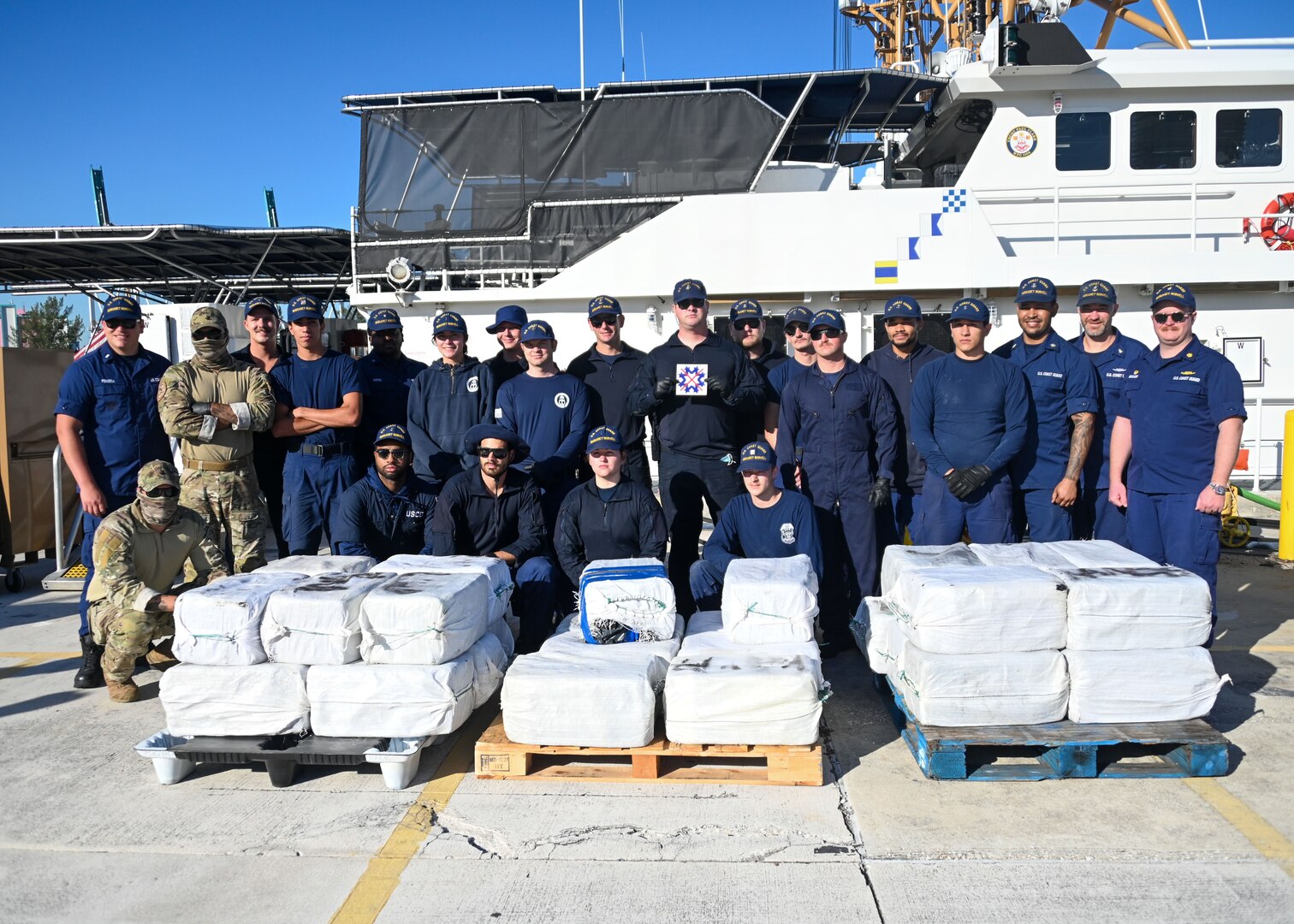 The crew of USCGC Margaret Norvell (WPC 1105) and Coast Guard Tactical Law Enforcement Team-South members celebrate a successful drug interdiction upon returning to homeport at Coast Guard Base Miami Beach, April 5, 2024. The crews interdicted a low-profile go-fast vessel carrying 30 bales of the illicit narcotics and detained five suspected smugglers approximately 190 miles south of Puerto Rico. (U.S. Coast Guard photo by Petty Officer 2nd Class Diana Sherbs)