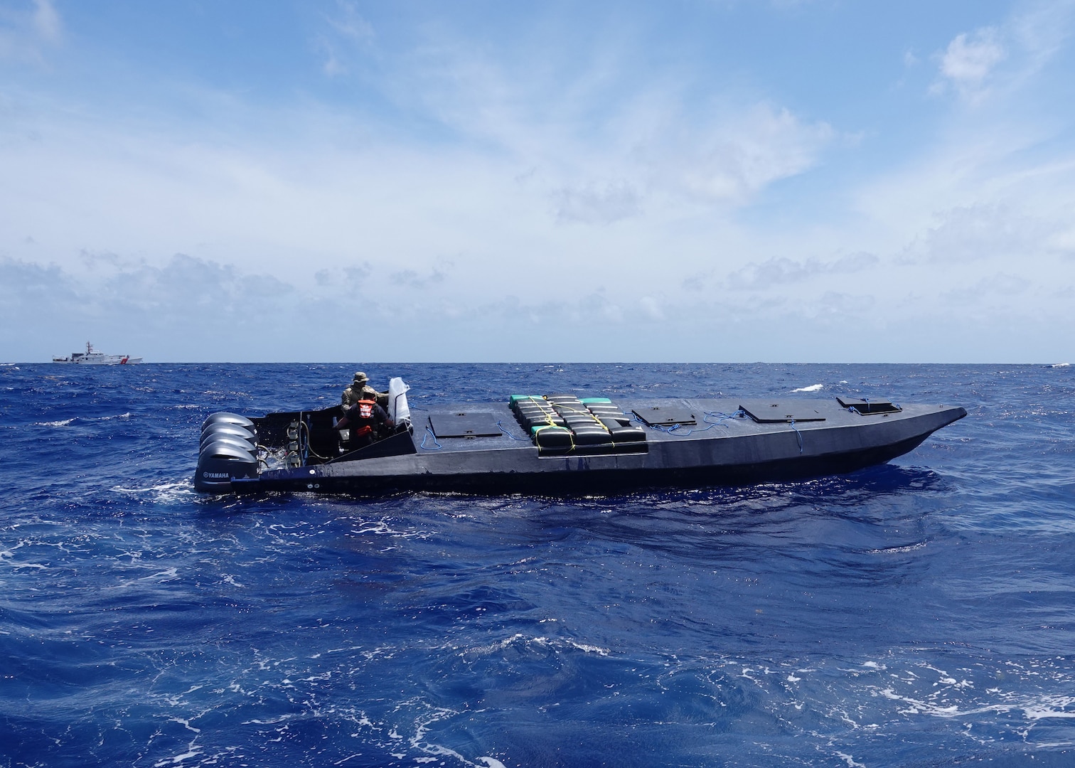Crew members from USCGC Margaret Norvell (WPC 1105) board a drug smuggling vessel carrying 30 bales of illegal narcotics approximately 190 miles south of Puerto Rico March 24, 2024. The bales weighed more than 1,850 pounds and have an estimated street value of approximately $24.3 million. (U.S. Coast Guard photo courtesy of the USCGC Margaret Norvell crew)