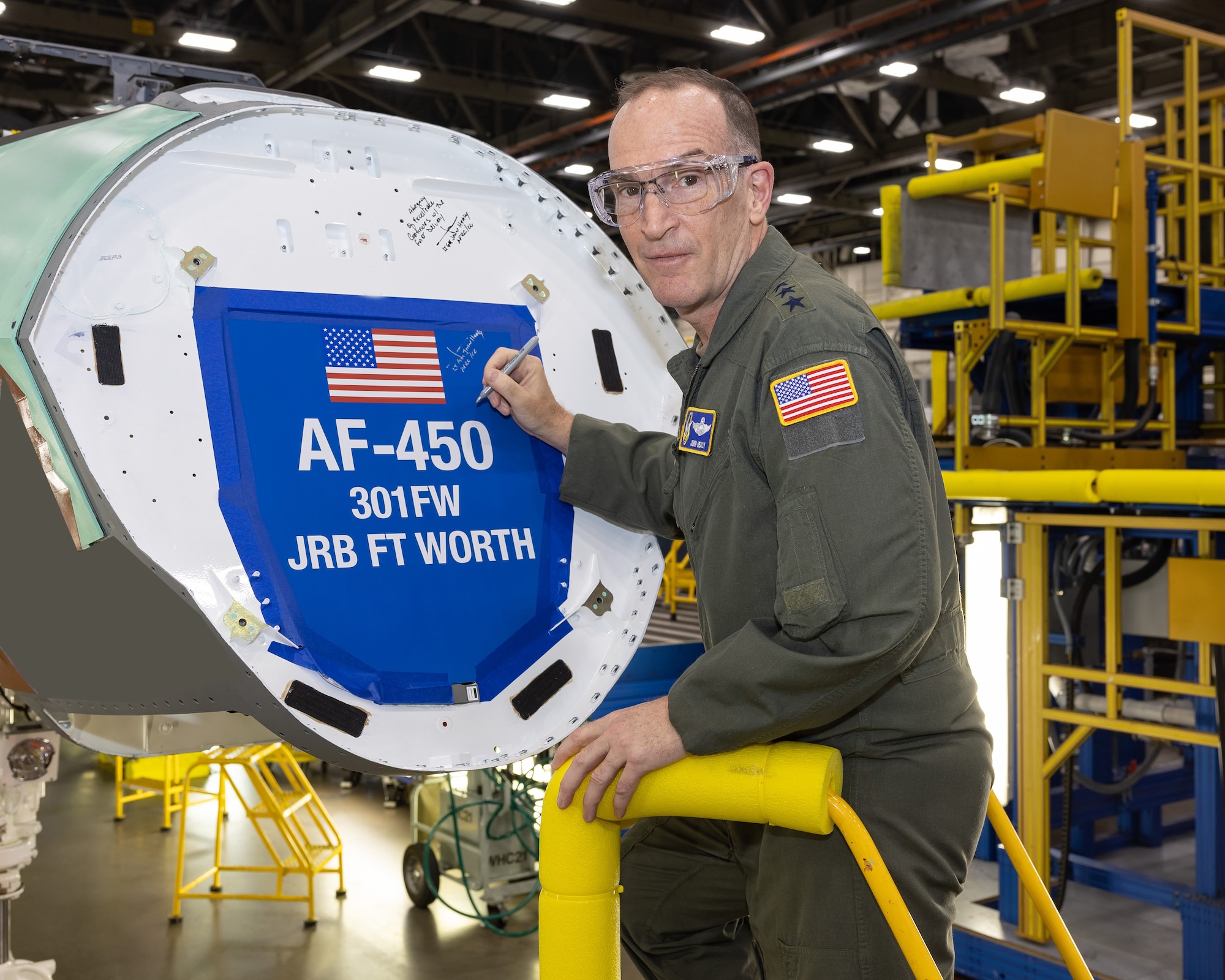 Lt. Gen. John Healy, commander Air Force Reserve Command, inscribes his signature onto the bulkhead of the first F-35 Lightning II for the 301st Fighter Wing, symbolizing a momentous leap forward in combat capabilities for the Air Force Reserves. (Photos courtesy of Lockheed Martin Aeronautics Company)
