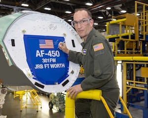 Lt. Gen. John Healy, commander Air Force Reserve Command, inscribes his signature onto the bulkhead of the first F-35 Lightning II for the 301st Fighter Wing, symbolizing a momentous leap forward in combat capabilities for the Air Force Reserves. (Photos courtesy of Lockheed Martin Aeronautics Company)