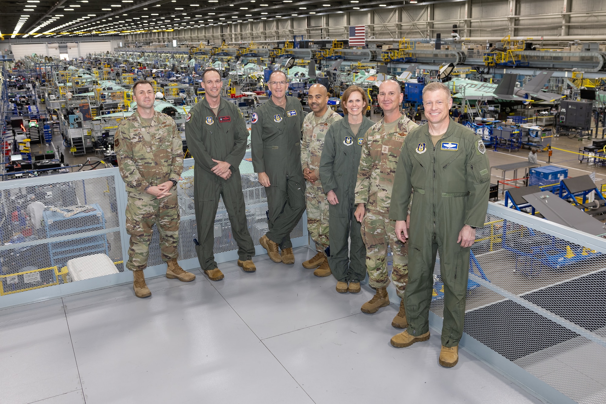 From left, 301st Fighter Wing Command Chief Master Sgt. Jonathan Rapelje, 301st Fighter Wing Commander Col. Benjamin R. Harrison, Lt. Gen. John Healy, commander of the Air Force Reserve Command, Air Force Reserve Command Chief Master Sgt. Israel Nunez, Brig. Gen. Gina Sabric, commander, 10th Air Force, Air Force Command Chief Master Sgt. Christopher S. Bluto, Jr., and 10th Air Force Deputy Commander Col. Allen Duckworth, stand above the massive F-35 production line April, 2 2024. (Photos courtesy of Lockheed Martin Aeronautics Company)