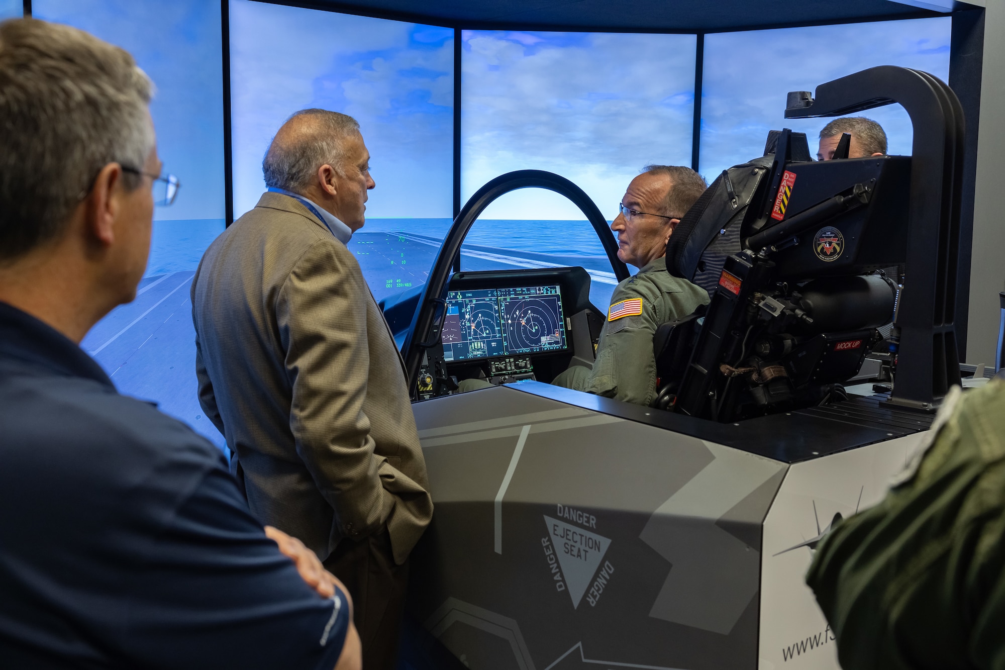 Lt. Gen. John Healy, Commander of Air Force Reserve Command, engages with the future of aviation through an F-35 cockpit simulator, during a tour of Lockheed Martin's production line, signaling a hands-on approach to modern warfare readiness. (Photos courtesy of Lockheed Martin Aeronautics Company)