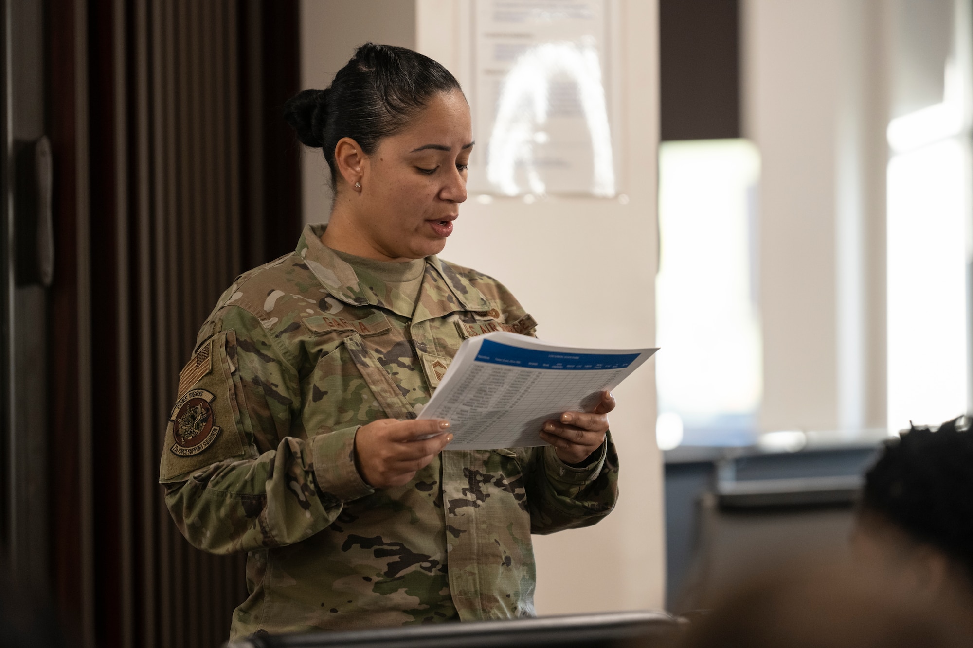 U.S. Air Force Senior Master Sgt. Laura Garcia, 23rd Force Support Squadron military personnel flight chief, briefs Airmen during an Exercise Ready Tiger personnel deployment function line