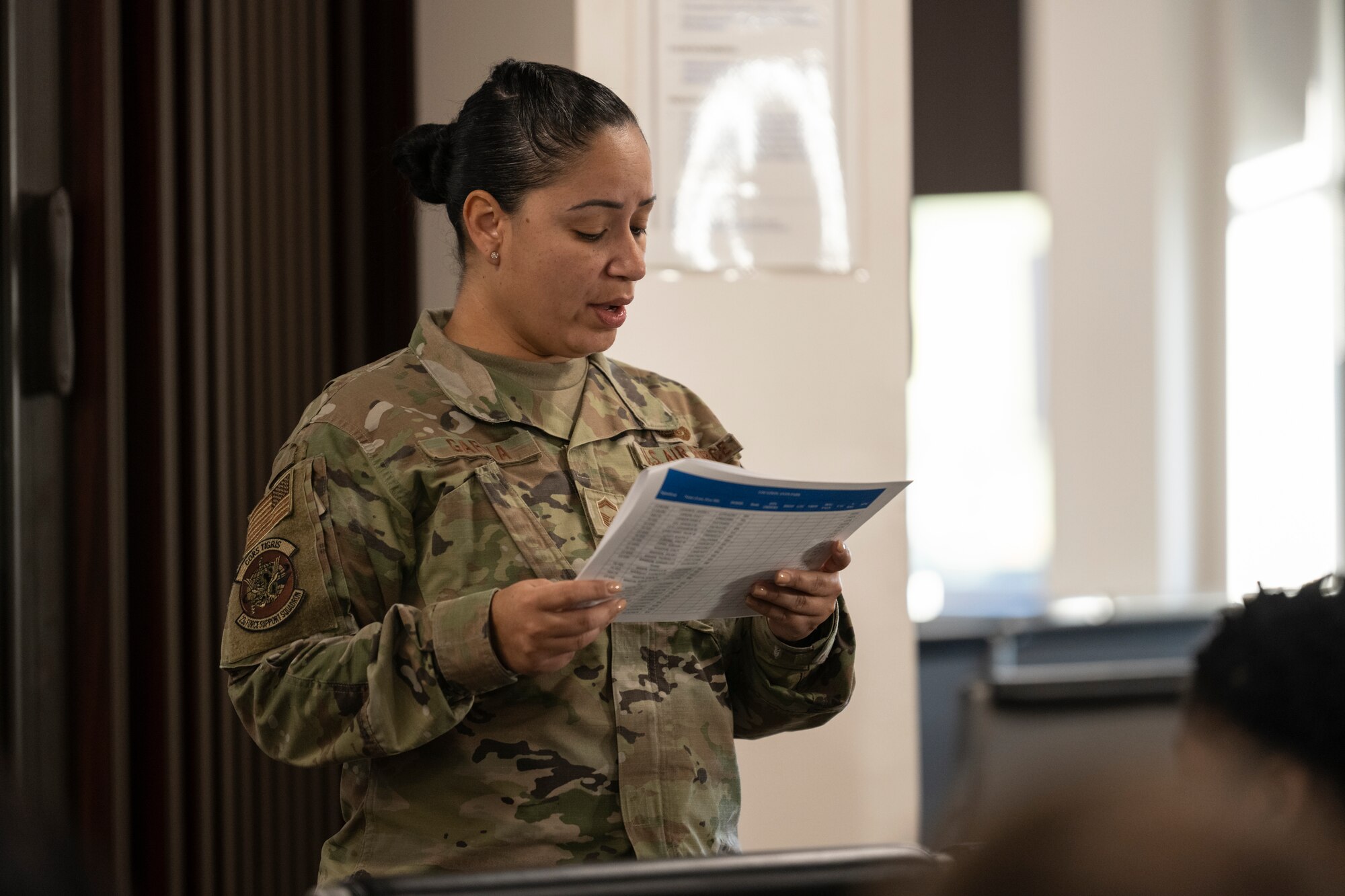 U.S. Air Force Senior Master Sgt. Laura Garcia, 23rd Force Support Squadron military personnel flight chief, briefs Airmen during an Exercise Ready Tiger personnel deployment function line