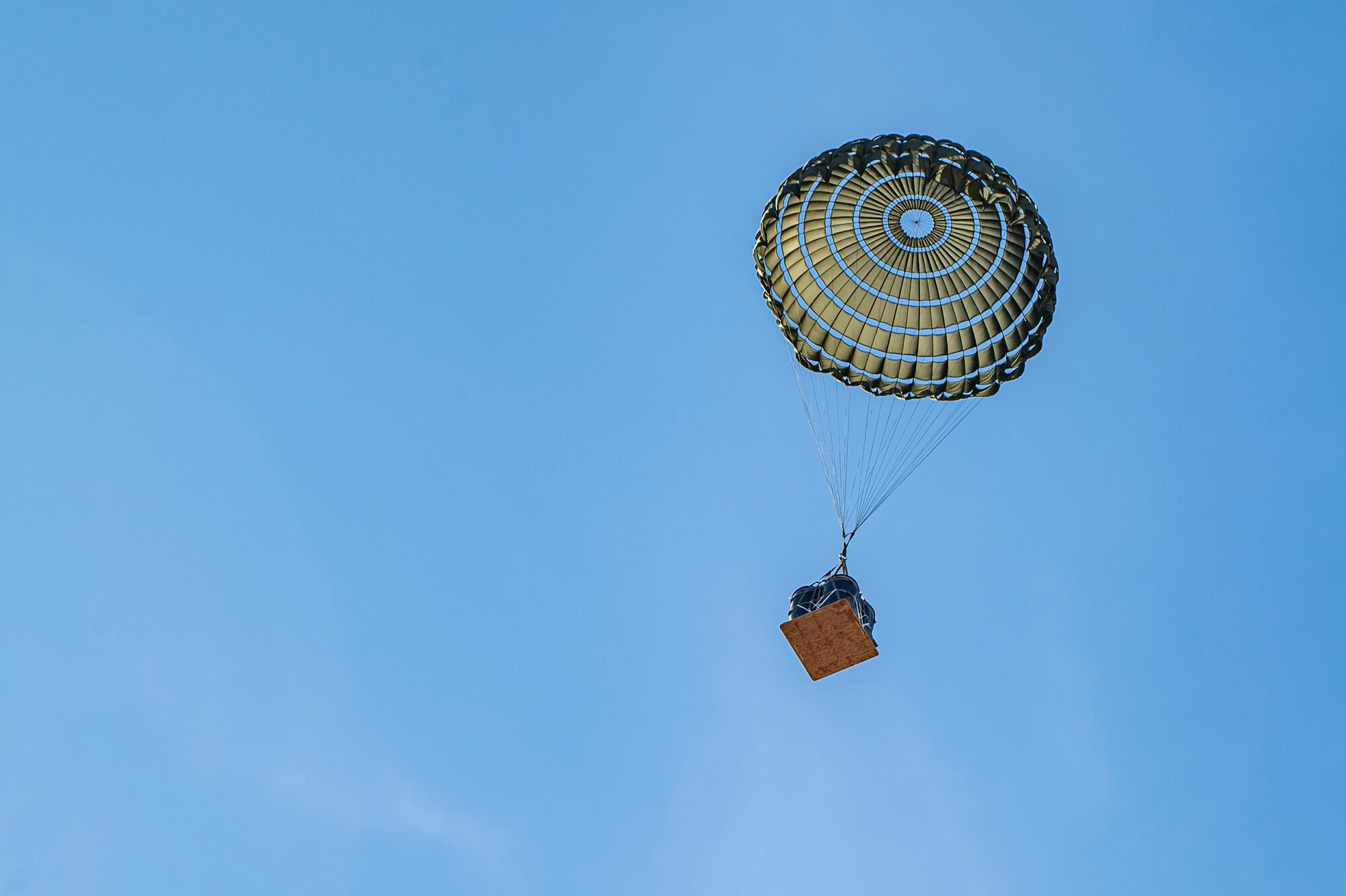 Cargo descends to the ground over Smoky Hill Air National Guard Range, Kansas, March 26, 2024. The cargo airdrop was part of a week-long Rescue Rodeo where six fixed-wing rescue squadrons trained and competed against each other. (U.S. Air Force photo by Airman 1st Class Leonid Soubbotine)