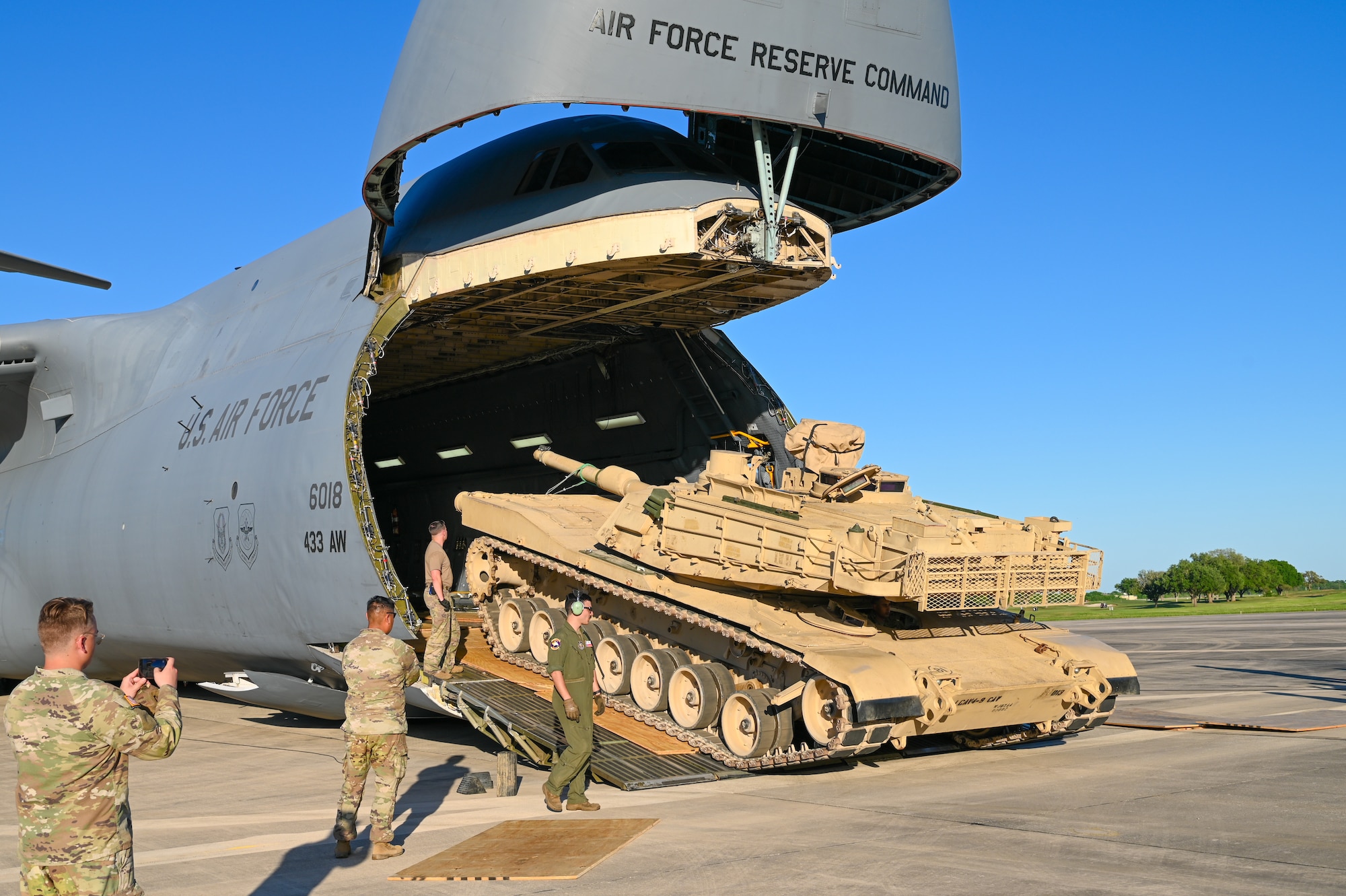 Reserve Citizen Airmen and Soldiers work together to unload a M1A2 Abrams Main Battle Tank from a C-5M Super Galaxy at Joint Base San Antonio-Randolph, Texas on April 4th, 2024.