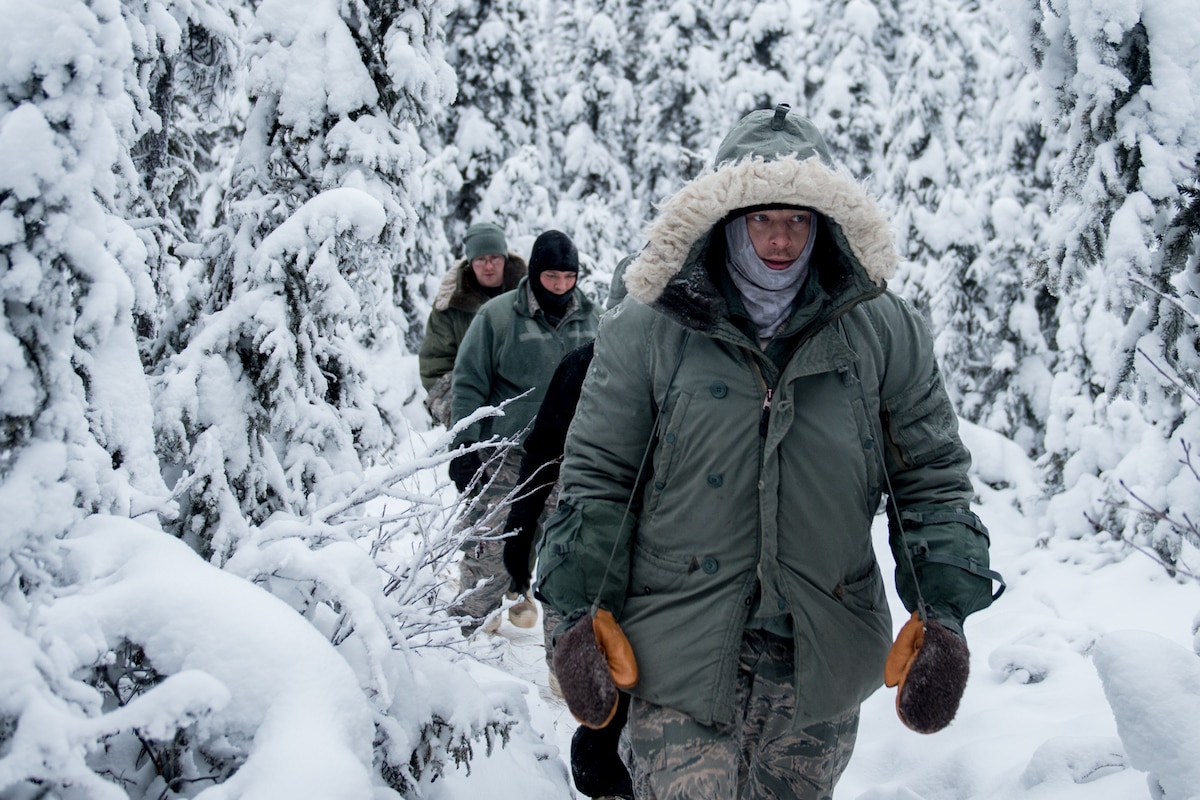 Airman head back to camp after checking snares during Arctic Survival School Dec. 13, 2018, on Eielson Air Force Base, Alaska.