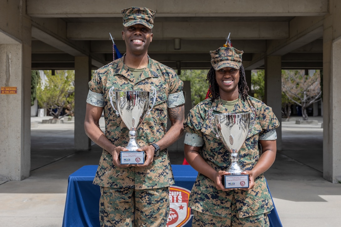 U.S. Marine Corps 1st Sgt. Harris, left, the company first sergeant with Weapons and Field Training Battalion at Edson Range, and Cpl. Jefferson, a new join program advisor with Headquarters and Service Company, 1st Supply Battalion, 1st Marine Logistics Group pose for a photo during the 2024 Camp Pendleton Male and Female Marine Athlete of the Year ceremony at MCB Camp Pendleton, California, April 4, 2024. Harris and Jefferson are recognized for their efforts in playing for the All-Marine Basketball Teams. (U.S. Marine Corps photo by Lance Cpl. Watts)