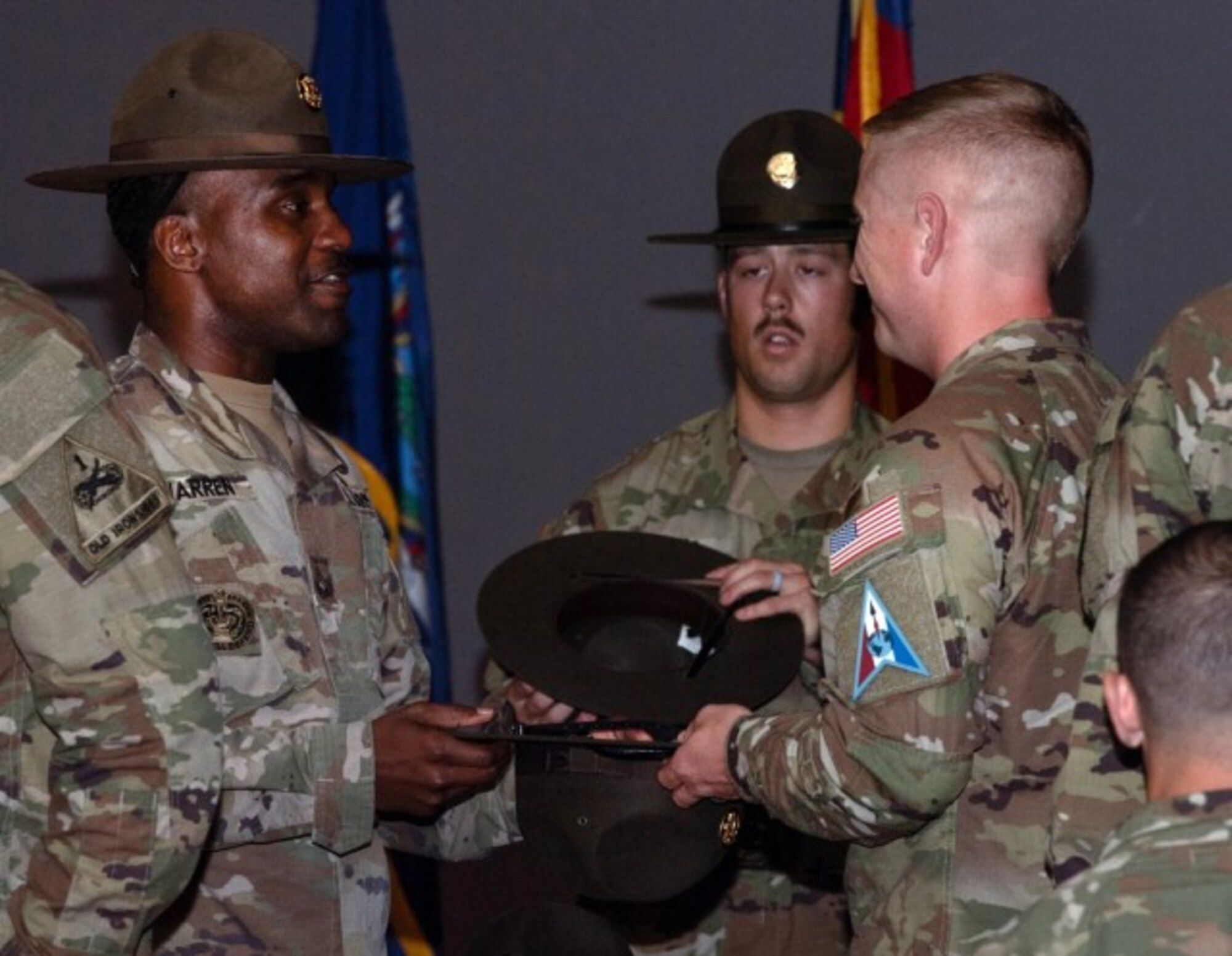 U.S. Army Sgt. 1st Class Sytoi K. Warren, senior drill sergeant leader, presents Space Force Tech Sgt. David P. Gudgeon his drill sergeant hat during a graduation ceremony at the U.S. Army Drill Sergeant Academy in Fort Jackson, S.C., April 3, 2024. Gudgeon, along with Sgt. Yuji Moore, were the first Guardians to graduate from the school. (U.S. Army photo by Robert Timmons)