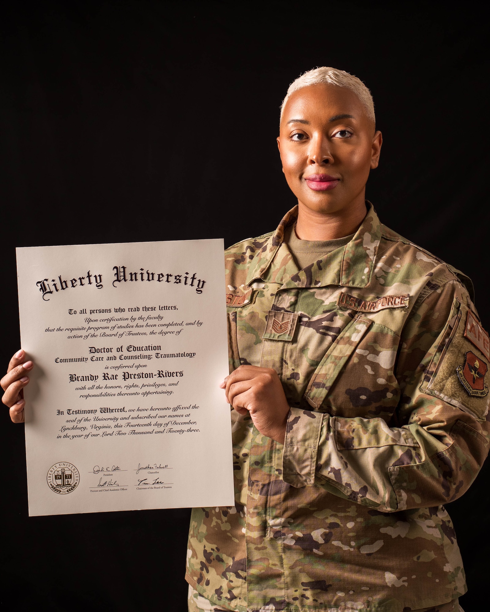 U.S. Air Force Tech. Sgt. Brandy Preston, 56th Operational Support Squadron aircrew flight equipment lead trainer, showcases her doctorate of community care and counseling, March 8, 2024, at Luke Air Force Base, Arizona.