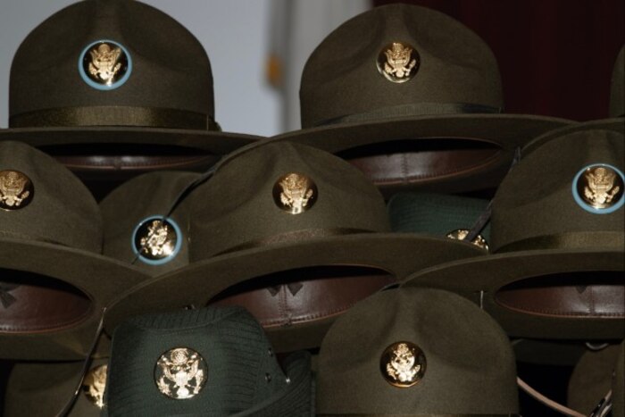 Drill sergeant hats wait to be awarded during the U.S. Army Drill Sergeant Academy graduation in Fort Jackson, S.C., April 3, 2024. Two Guardians were the first service members from sister services to graduate from the academy. (U.S. Army photo by Robert Timmons)