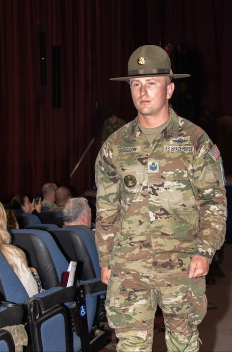Tech Sgt. David P. Gudgeon, a new graduate from the U.S. Army Drill Sergeant Academy's Class 006-24, marches up the aisle after receiving his drill sergeant hat during the U.S. Army Drill Sergeant Academy graduation in Fort Jackson, S.C., April 3, 2024. Gudgeon was one of first Guardians to graduate from the academy (U.S. Army photo by Robert Timmons)