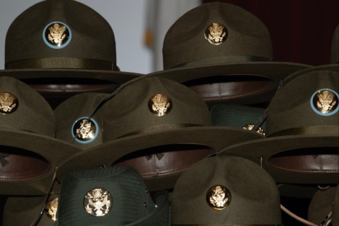 Drill sergeant hats wait to be awarded during the U.S. Army Drill Sergeant Academy graduation in Fort Jackson, S.C., April 3, 2024. Two Guardians were the first service members from sister services to graduate from the academy. (U.S. Army photo by Robert Timmons)