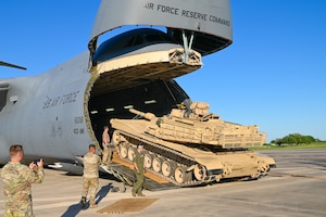Reserve Citizen Airmen and Soldiers work together to unload a M1A2 Abrams Main Battle Tank from a C-5M Super Galaxy at Joint Base San Antonio-Randolph, Texas on April 4th, 2024.