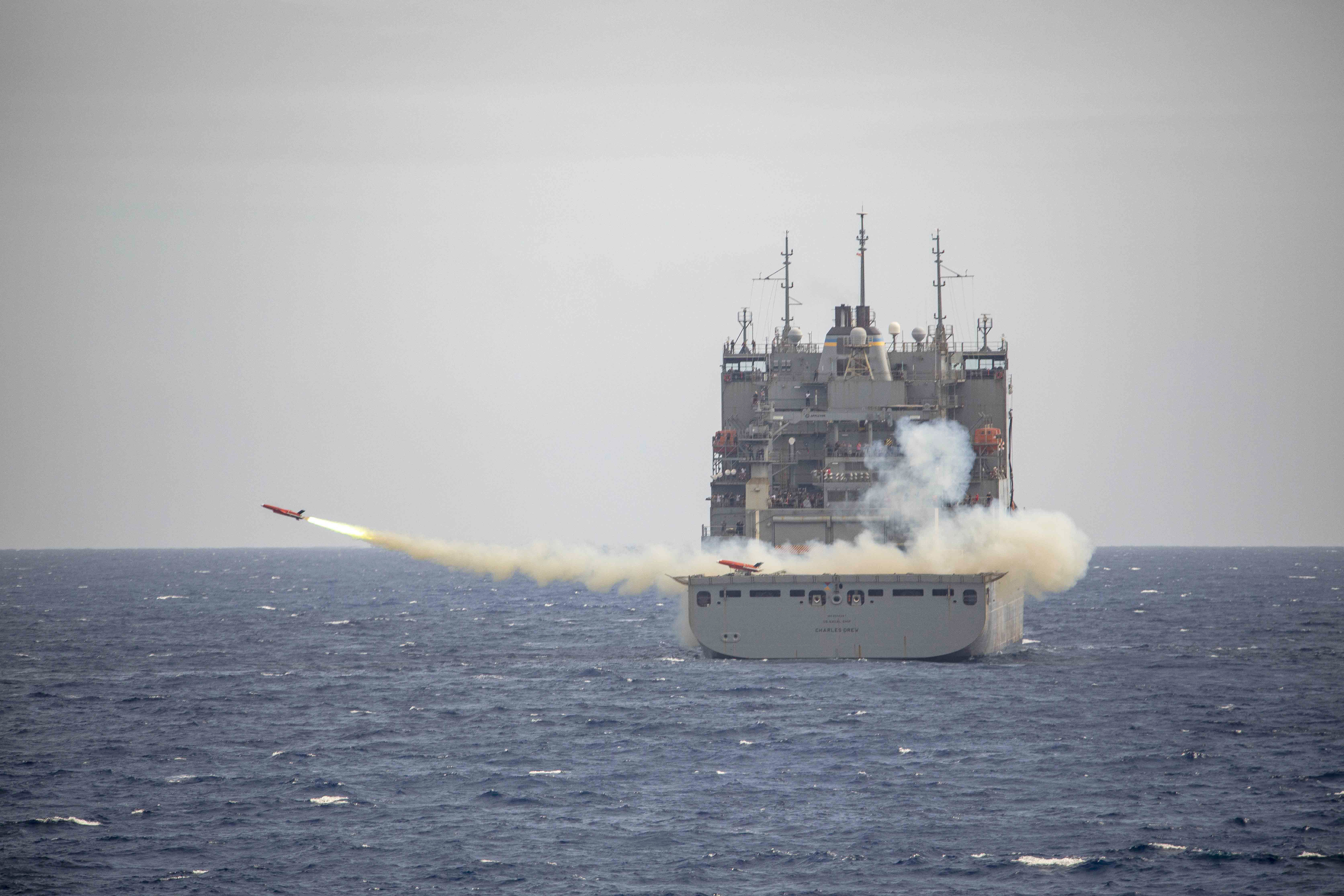 USNS Charles Drew (T-AKE 10) launches a drone during a live-fire exercise in the Philippine Sea.