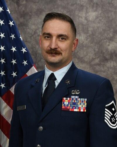 U.S. Air Force Master Sgt. Joshua Waters, first sergeant for the 117th Air Refueling Wing Medical Group, poses for an official photo at Sumpter Smith JNGB, Ala., Jan. 6, 2024. (U.S. Air National Guard photo by Senior Airman Kasie Faddis)