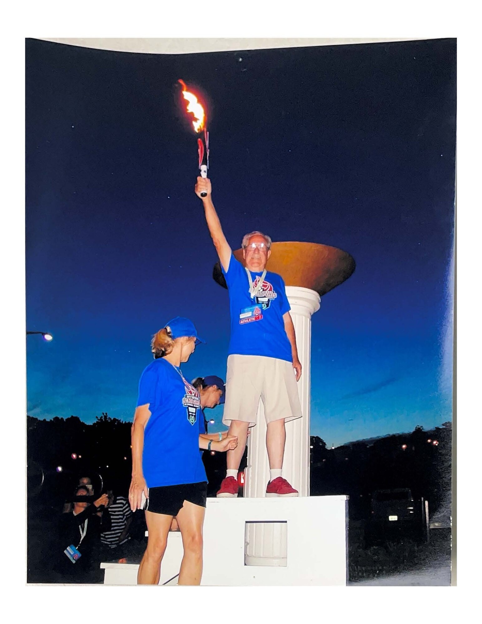 A photo provided to the 117th Air Refueling Wing Public Affairs Office on January 5, 2024, at Sumpter Smith Joint National Guard Base, Birmingham, Alabama. The photo shows Millard “Bo” Carwyle, a U.S. Army and World War ll veteran, holding the Olympic torch for the lighting of the 2017 National Senior Olympics in Birmingham, Alabama, on June 2, 2017. (U.S. Air Force Courtesy Photo)
