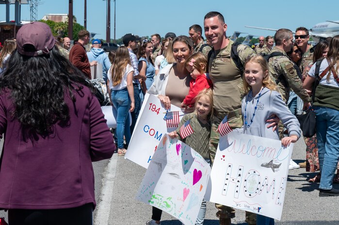 A photo of a family posing for a photo.