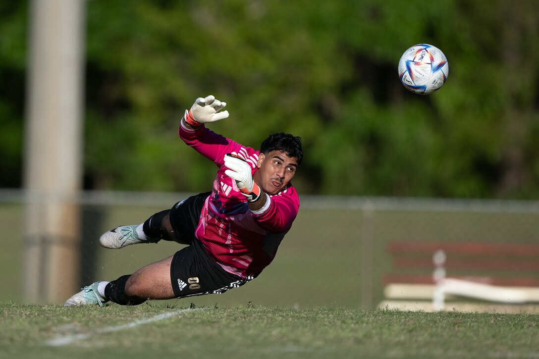 Navy goalkeeper Petty Officer 3rd Class Nour Moaoui of NB San Diego, Calif. deflects Air Force goal attempt during match 1 of the 2024 Armed Forces Men's Soccer Championship hosted by Marine Corps Logistics Base Albany, Georgia at Albany State University from April 2-10. The Armed Forces Championship features teams from the Army, Marine Corps, Navy (with Coast Guard players), and Air Force (with Space Force players). (DoD photo by EJ Hersom)