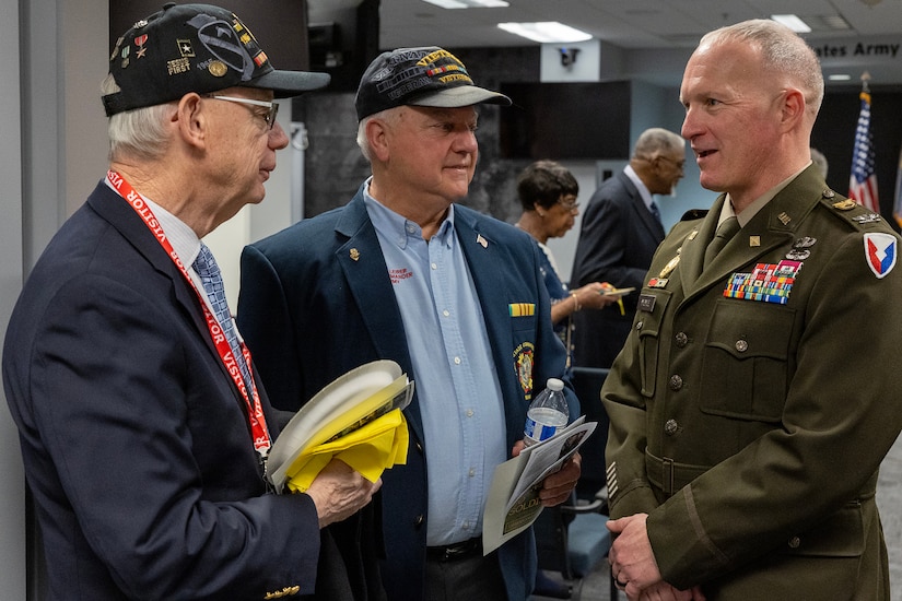 Retired U.S. Army Lt. Col. (Dr.) Richard Storm, left, and Richard Leirer, center, talk with U.S. Army Col. Kevin Pierce, U.S. Army Financial Management Command chief of staff, after USAFMCOM’s Vietnam War commemoration at the Maj. Gen. Emmett J. Bean Federal Center in Indianapolis March 25, 2024. Storm flew CH-47 Chinook helicopters in Vietnam from 1969-1970, earning two Distinguished Flying Crosses and 28 Air Medals, and Leirer served two combat tours in Vietnam with assault helicopter companies. (U.S. Army photo by Mark R. W. Orders-Woempner)