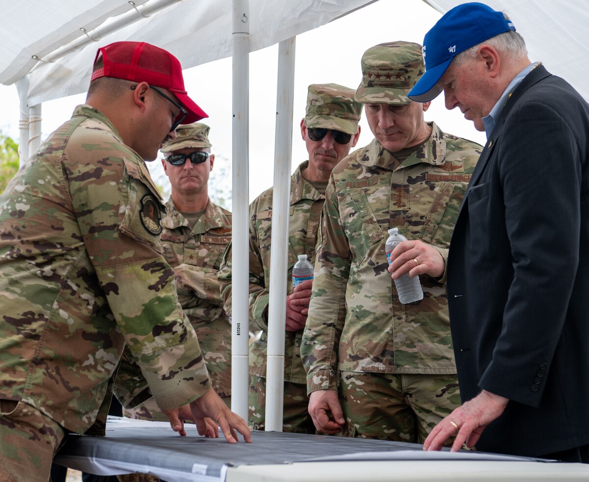 U.S. Secretary of the Air Force Frank Kendall, Air Force Chief of Staff Gen. David Allvin and Chief Master Sergeant of the Air Force David Flosi meet with Capt. Matthew Jacobs, Tinian officer in charge of the 513th Expeditionary Rapid Engineer Deployable Heavy Operations Repair Squadron Engineers Squadron, who shows the map of the airfield on Tinan, April 4, 2024. While in Tinian, leadership gained first-hand knowledge of how the 356th Expeditionary Civil Engineering Group is implementing change to further agile combat employment and how relationships with neighboring islands are paramount to the Air Force’s future success in Great Power Competition. (U.S. Air Force photo by Airman 1st Class Audree Campbell)