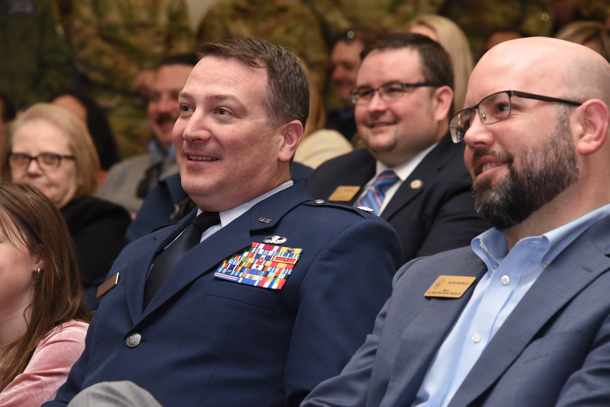 U.S. Air National Guard Lt. Col. Benjamin Uhl, the Director of Operations for Iowa Air National Guard, left, is seated next to Representative Jacob Bossman, the State Representative for Iowa’s Sixth District and Regional Director for Iowa Senator Chuck Grassley, right