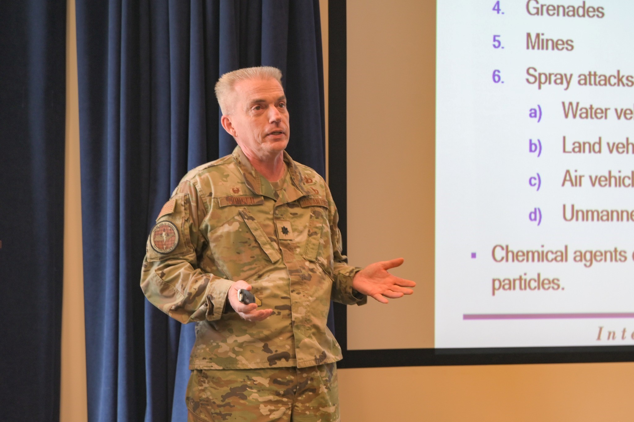 U.S. Air Force Lt. Col. John P. Conger briefs members of the 164th Airlift Wing's Headquarters Squadron on how to identify chemical, biological, radiological and nuclear attacks. This Ready Airmen Training, an Air Force initiative, is designed to prepare the force for a deployed environment. (U.S. Air Force Photos by Staff Sgt. Jackson Brown)