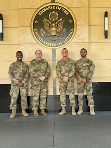 U.S. Army Capt. Michael Humphrise, U.S. Army Maj. Bill Seskey, U.S. Army Lt. Col. Tyson Mele, and U.S. Army Sgt. 1st Class Jurgen Soekhoe stand for a group photo outside the U.S. Embassy in Kingston, Jamaica, Feb. 21, 2024.  Members of the District of Columbia Army National Guard joined forces with elite units from the U.S. and Canada for a Special Operations Forces (SOF) Subject Matter Expert Exchange (SMEE).