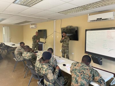 U.S. Army Sgt. 1st Class Jurgen Soekhoe leads a discussion on troop leading procedures and operations orders with Jamaican Defense Force (JDF) partners in Kingston, Jamaica, Feb. 21, 2024.  Members of the District of Columbia Army National Guard joined forces with elite units from the U.S. and Canada for a Special Operations Forces (SOF) Subject Matter Expert Exchange (SMEE).