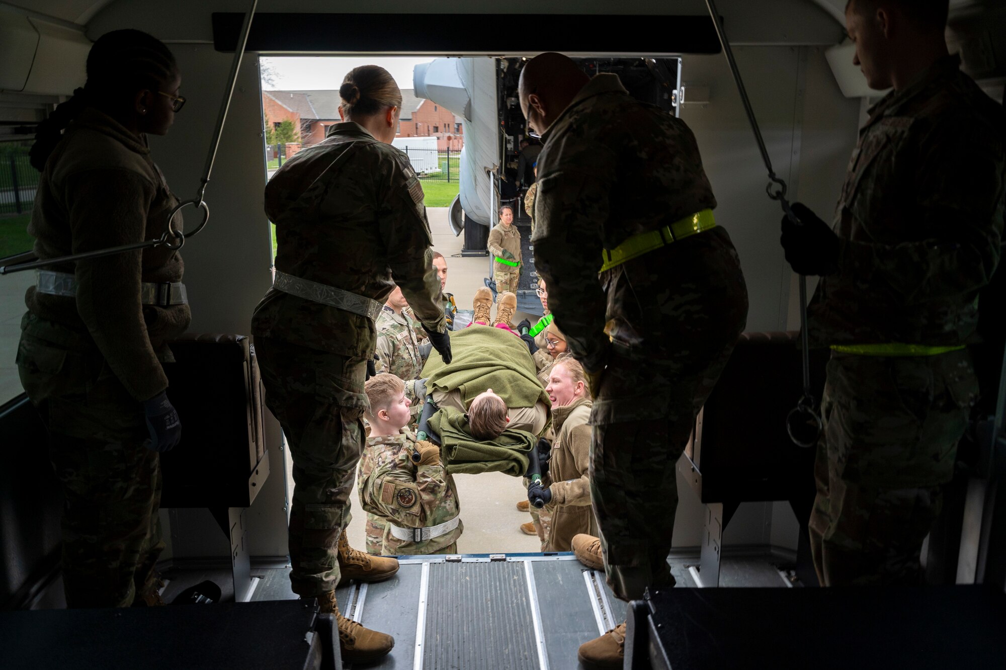 Airmen from the 932nd Aeromedical Evacuation Squadron and the 932nd Aeromedical Staging Squadron help load a patient onto a bus during the Spartan Reserve exercise at Scott Air Force Base, Illinois on April 7, 2024. The Spartan Reserve Phase II exercise aims to prepare airmen for complexities of modern warfare through recreating the challenges in a deployed environment. (U.S. Air Force Photo by Tech. Sgt. Kari Siltz)