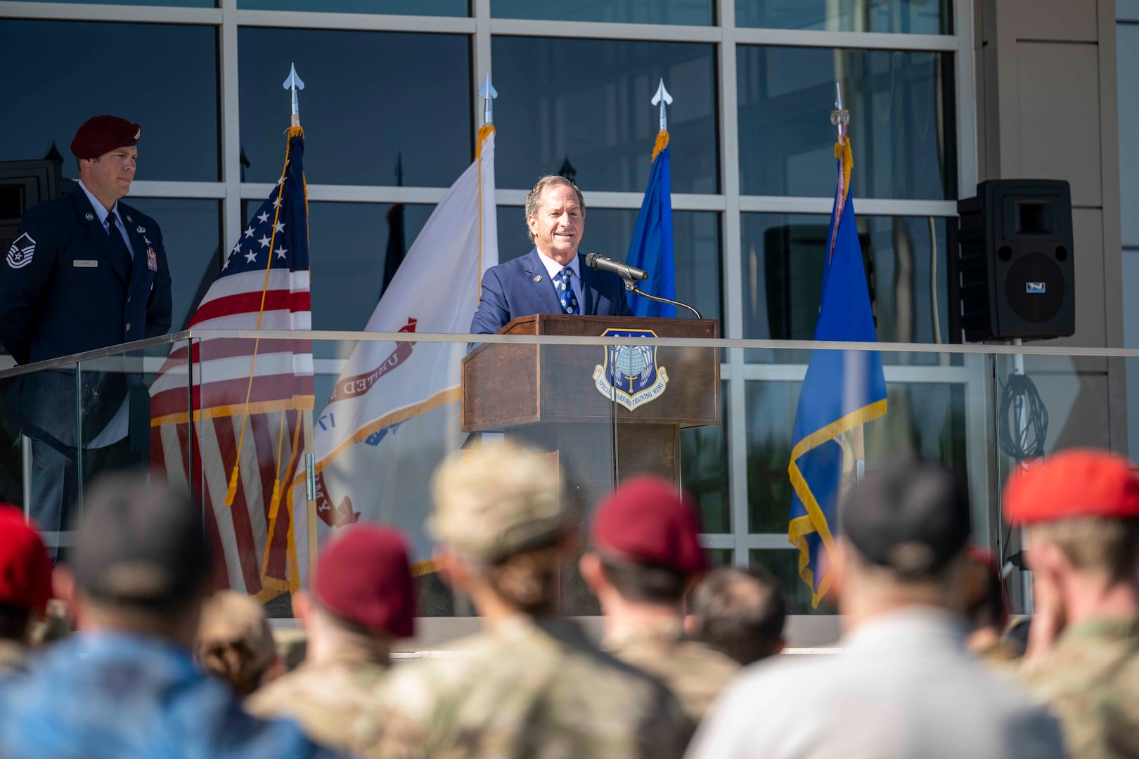 A man gives opening remarks at the grand opening of the Maltz Special Warfare Aquatic Training Center.