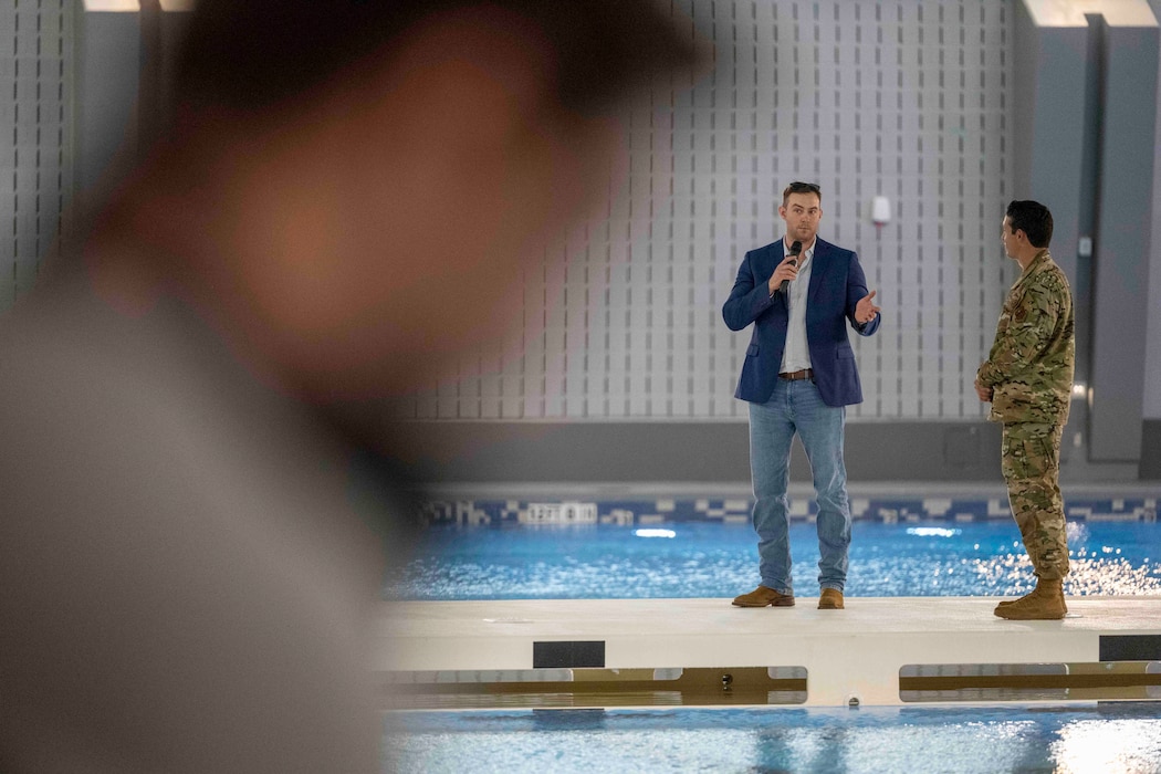 Cody Maltz (center), son of fallen pararescueman U.S. Air Force Master Sgt. Michael Maltz, gives remarks on the pool deck at the grand opening of the Maltz Special Warfare Aquatic Training Center.