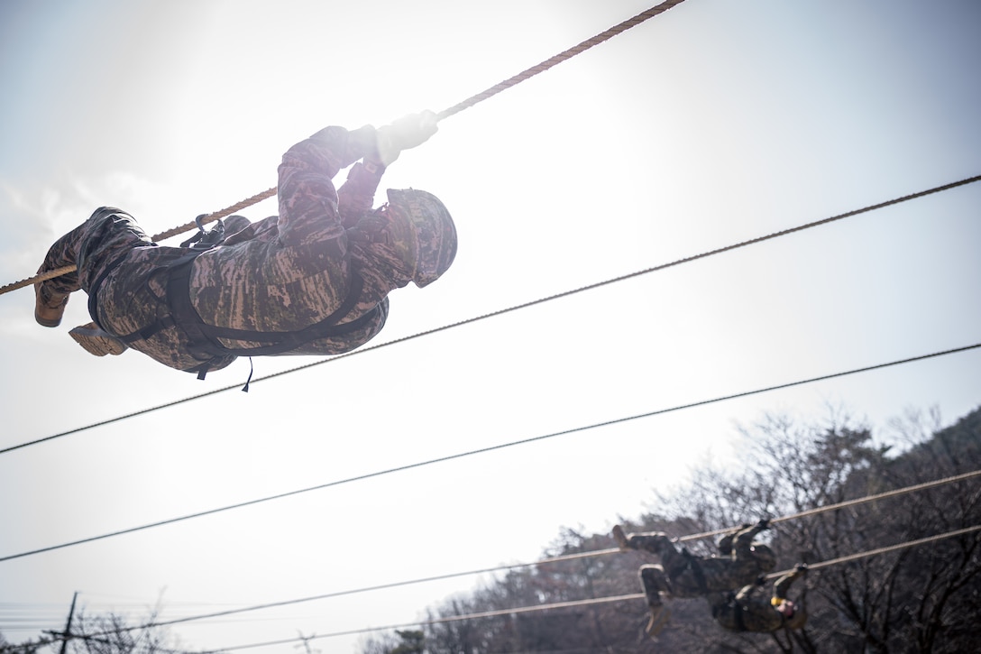 A Republic of Korea Marine crosses a rope bridge during Warrior Shield 24 at ROK Marine Corps Base Pohang, South Korea, March 14, 2024. Warrior Shield 24 is an annual joint, combined exercise held on the Korean Peninsula that seeks to strengthen the combined defensive capabilities of ROK and U.S. forces. This routine, regularly scheduled, field training exercise provides the ROK and U.S. Marines the opportunity to rehearse combined operations, exchange knowledge, and demonstrate the strength and capabilities of the ROK-U.S. Alliance. The Marine is with 23rd Battalion, 1st ROK Marine Division. (U.S. Marine Corps photo by Lance Cpl. Matthew Morales)
