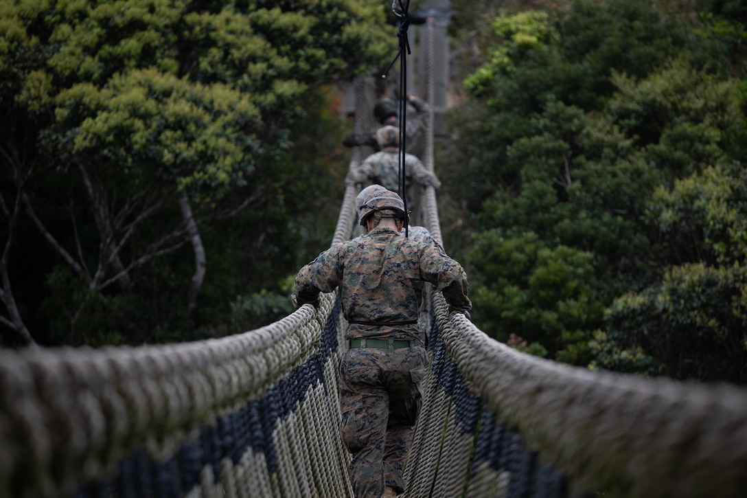 U.S. Marines cross a rope bridge during Jungle Leaders Course at the Jungle Warfare Training Center, Okinawa, Japan, March 19, 2024. The Jungle Leaders Course is designed to prepare U.S. and Allied forces for operations in austere jungle environments. The Marines are with 4th Marine Regiment, 3rd Marine Division. (U.S. Marine Corps photo by Lance Cpl. Kendrick Jackson)