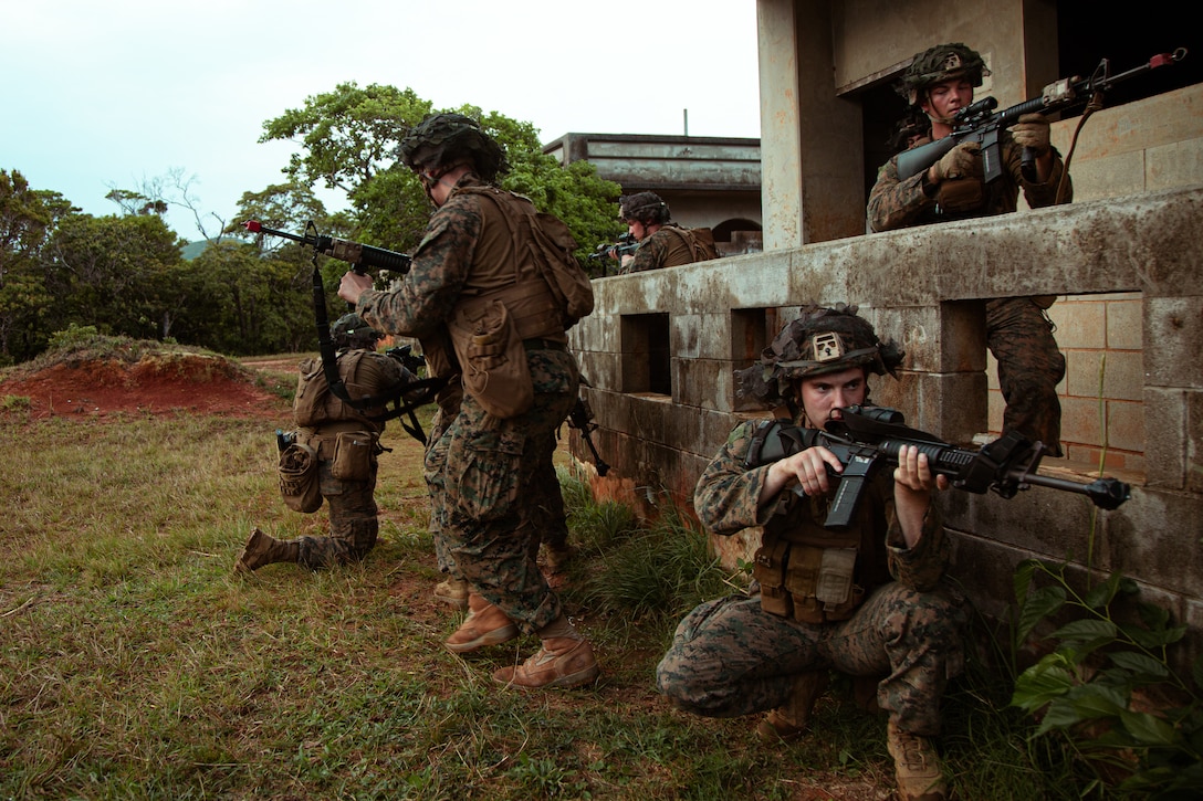 U.S. Marine Corps combat engineers with Marine Wing Support Squadron 172, Marine Aircraft Group 36, 1st Marine Aircraft Wing, establish security as they extract a simulated high value target during training in Combat Town, Camp Hansen, Okinawa, Japan, March 31, 2024. The exercise provided explosive ordinance disposal technicians and combat engineers with scenarios designed to enhance their skills in counter improvised explosive device operations. (U.S. Marine Corps photo by 2nd Lt. John Sagan)
