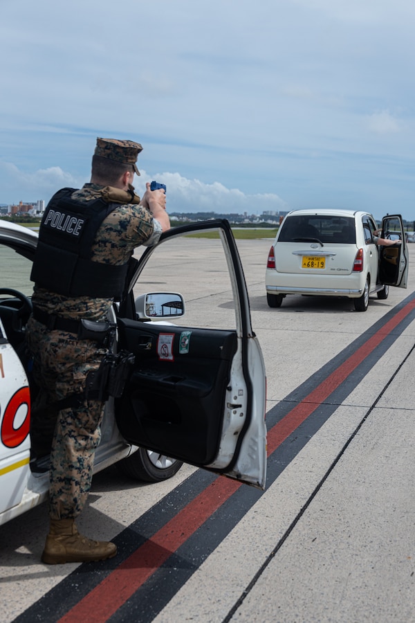 U.S. Marine Corps Sgt. Donald Bracey, a military police officer with the Provost Marshal’s Office, Headquarters and Support Battalion, Marine Corps Installations Pacific, stops a vehicle during a flight line breach training as part of exercise Resolute Response on Marine Corps Air Station Futenma, Okinawa, Japan, April 1, 2024. The exercise is a two-week training event to test base defenses through the enhanced response of the MCAS Futenma Emergency Operations Center. An EOC provides a commanding officer with single point command and control of installation facilities, resources, and support functions during an emergency in order to maintain situational awareness and support timely decision-making. Bracey is a native of Florida. (U.S. Marine Corps photo by Lance Cpl. Brody Robertson)