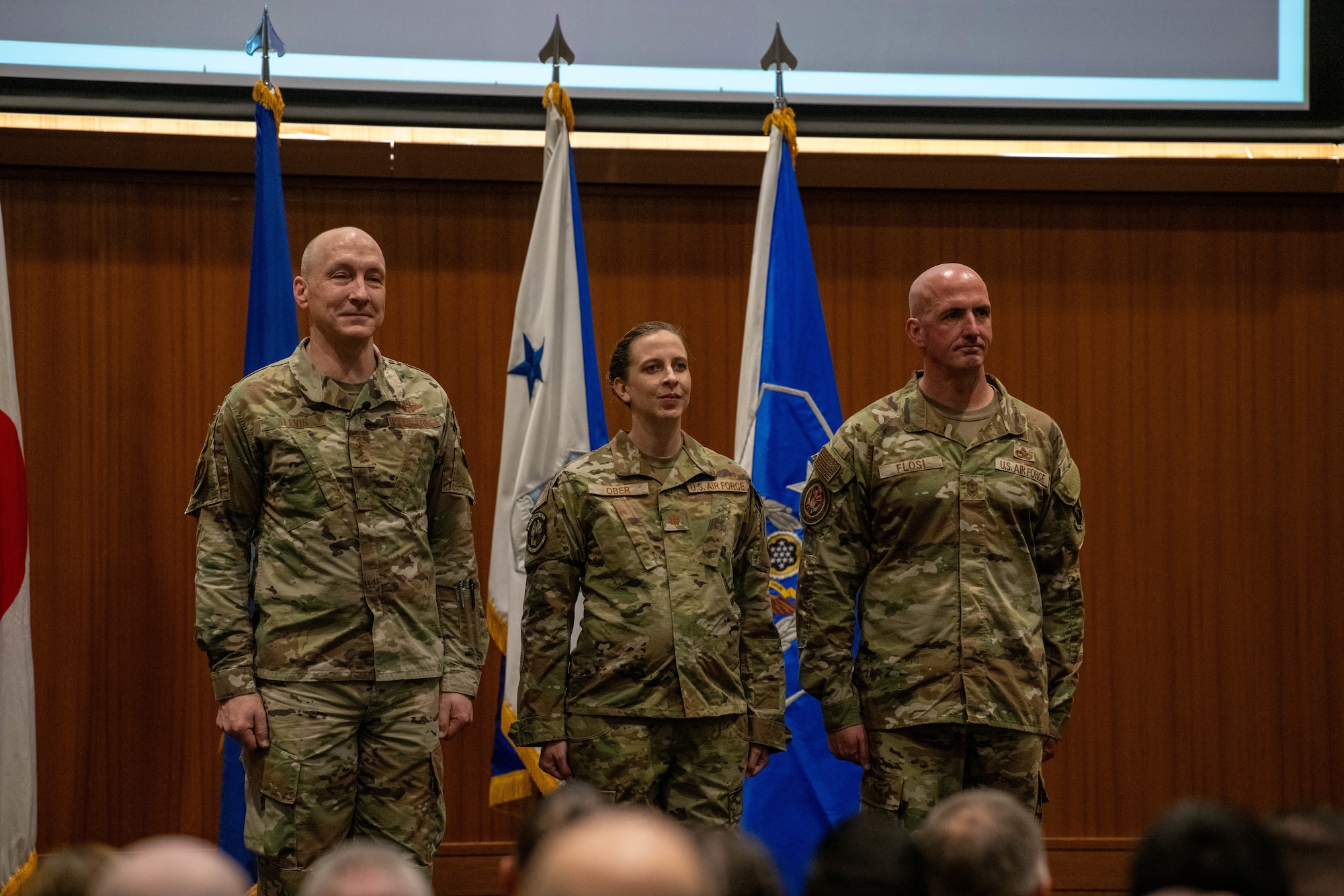 CMSAF, CSAF and U.S. Air Force Major Kristin Ober stand at attention.