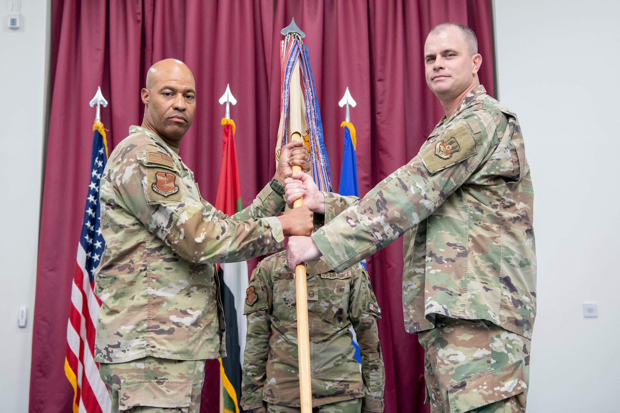 U.S. Air Force Command Chief Master Sgt. Chief Christopher Murphy, command chief of the 380th Air Expeditionary Wing, relinquishes responsibility of the 380th AEW to Brig. Gen. Terence Taylor, outgoing commander of the 380th Air Expeditionary Wing, during a combined change of command and change of responsibility ceremony at an undisclosed location within the U.S. Central Command area of responsibility, April 1, 2024.