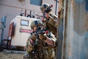 U.S. Air Force Staff Sgt. Chandler Chase, left, 51st Logistics Readiness Squadron fuels supervisor, and Airman 1st Class Alan Yanez, 51st Security Forces Squadron Defender, scan the area for simulated opposing forces during a Combat Readiness Course at Osan Air Base, Republic of Korea, March 14, 2024. The CRC equips Airmen with advanced combat tactics and life saving skills, enabling them to confront any challenge and deter adversaries in defense of Osan AB and the ROK. (U.S. Air Force photo by Staff Sgt. Thomas Sjoberg)