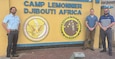 Assistant Special Agent-in-Charge of Forward Missions in Europe and Africa David Salazar stands with Special Agents Brian Mansfield and Ryan Budde at the entrance to Camp Lemonnier, Republic of Djibouti.