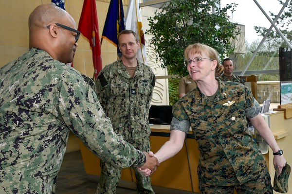 Top Devil Dog Doc welcomed… U.S. Navy Rear Adm. Pamela Miller, medical officer of the Marine Corps is greeted by acting Command Master Chief David Green at Navy Medicine Readiness and Training Command Bremerton before beginning a familiarization visit and tour of the command, April 4, 2024, which included specific stops to meet with staff assigned to Family Medicine, Urgent Care Clinic, Mental Health department and Patient Administration department. Miller also toured the branch health clinic, Navy Medicine Readiness Training Unit Bangor (Official Navy photo by MC2 Jennifer Benedict, NMRTC Bremerton public affairs).