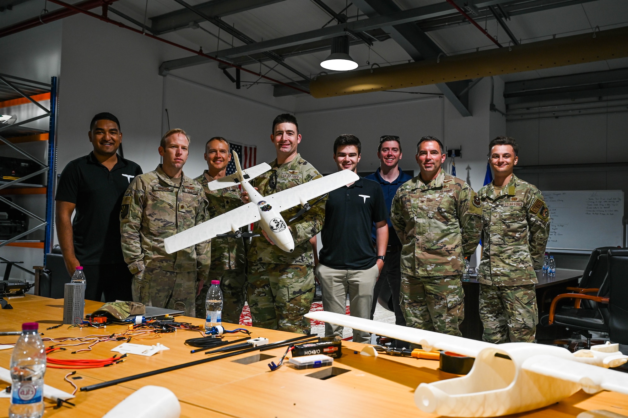 Group poses for a photo with a UAS.