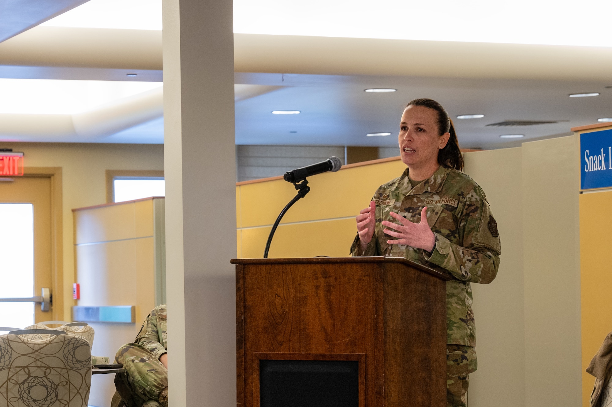 A woman in uniform speaking into a microphone