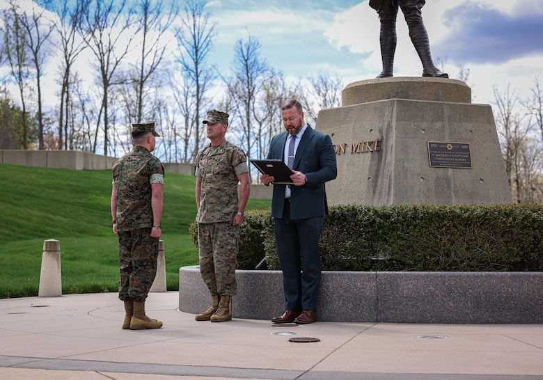U.S. Marine Corps Staff Sgt. Jonathan Cerecedes, left, a Surprise, Arizona, native and watch commander with Provost Marshal Office, Maj. Michael Flanigan, Security Battalion's executive officer, both with Marine Corps Base Quantico, and retired Master Sgt. Bradley Harding conduct a meritorious promotion ceremony at the National Museum of the Marine Corps, Triangle, Virginia, April 5, 2024. Cerecedes competed with approximately 13,000 staff sergeants in the Marine Corps for 21 slots to meritoriously promote to gunnery sergeant, and beat about 99 percent of the Marines for that promotion. (U.S. Marine Corps photo by Lance Cpl. Sean R. LeClaire)