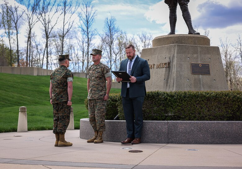 U.S. Marine Corps Staff Sgt. Jonathan Cerecedes, left, a Surprise, Arizona, native and watch commander with Provost Marshal Office, Maj. Michael Flanigan, Security Battalion's executive officer, both with Marine Corps Base Quantico, and retired Master Sgt. Bradley Harding conduct a meritorious promotion ceremony at the National Museum of the Marine Corps, Triangle, Virginia, April 5, 2024. Cerecedes competed with approximately 13,000 staff sergeants in the Marine Corps for 21 slots to meritoriously promote to gunnery sergeant, and beat about 99 percent of the Marines for that promotion. (U.S. Marine Corps photo by Lance Cpl. Sean R. LeClaire)