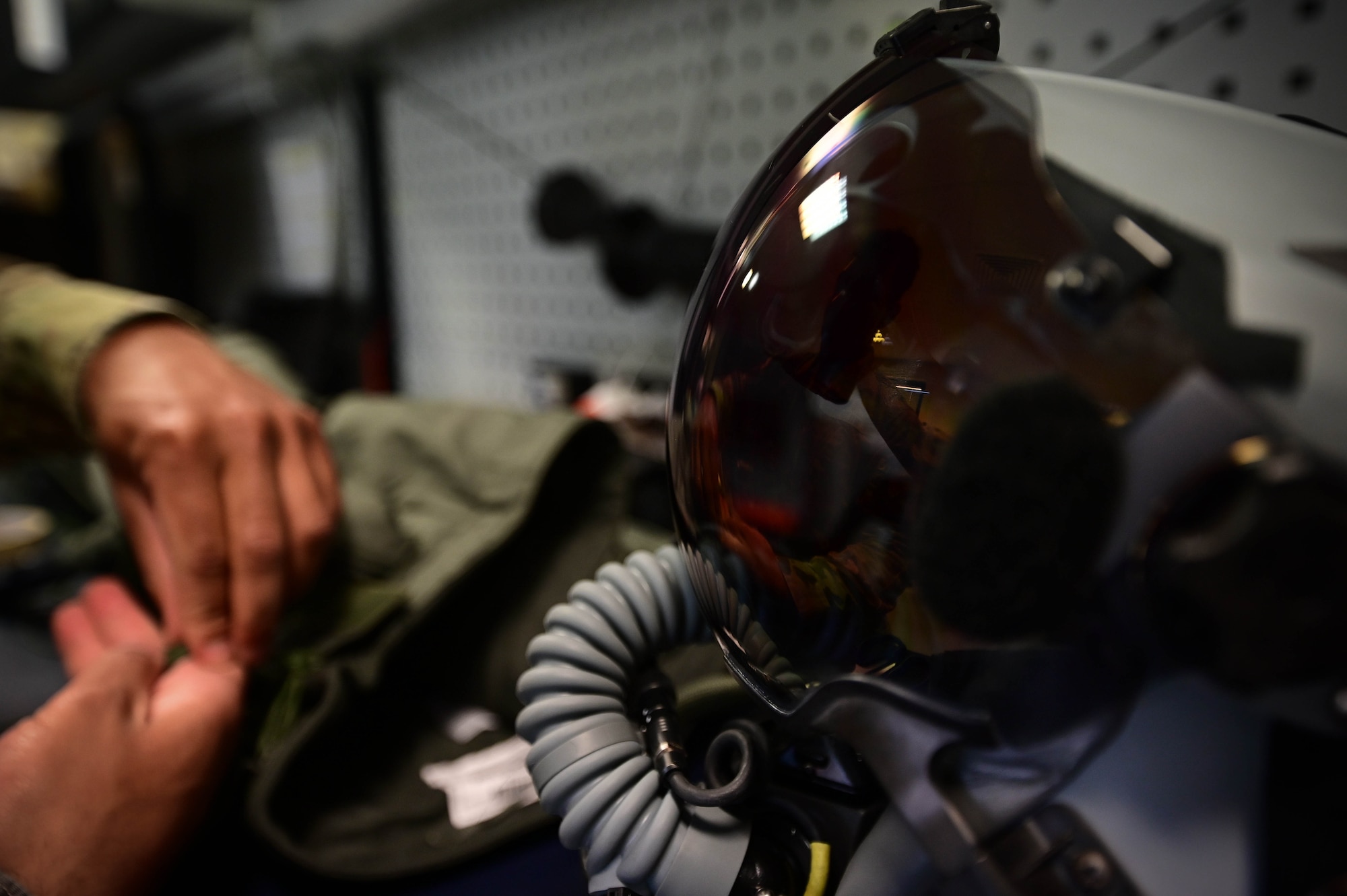 An Airman inspects a flight suit.