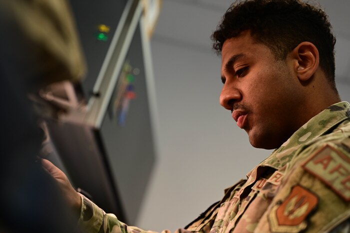 An Airman conducts a routine check of a flight suit.