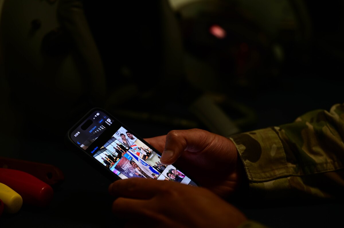 An Airman views family photos.